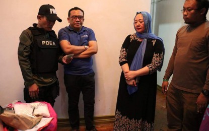 <p>Lanao del Sur Board Member Hussien Magandia (2nd from left) and wife Norhaima, during the recovery of more or less half a kilo of suspected shabu from the bedroom of their house in Bacayo, Tubod, Iligan City, in an early morning anti-drug operation, September 19, by the Philippine Drug Enforcement Agency Region 10 and the Autonomous Region in Muslim Mindanao (ARMM). <em>(Photo: PDEA Region 10)</em></p>