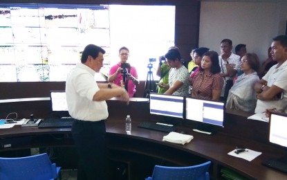 <p><strong>BACKFLOODS.</strong> Governor Wilhelmino Sy-Alvarado shows newsmen the areas affected by backfloods on the virtual monitoring system at the Operation Center of Bulacan Provincial Disaster Risk Reduction and Management Office, Sept. 19, 2018. <em>(Photo by Manny Balbin)</em></p>