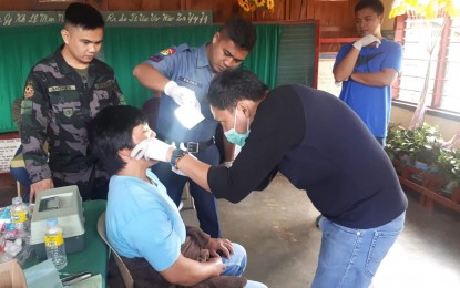<p><strong>POLICE SERVICE</strong>. San Nicolas policemen assist a medical and dental mission led by Civil Service Commission (CSC) Urdaneta City field office during the celebration of CSC Month. <em>(Photo courtesy of San Nicolas Police Station) </em></p>