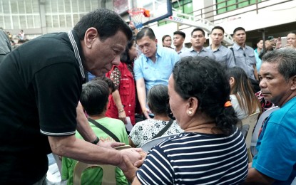 <p><strong>SYMPATHIZING WITH THE FAMILIES.</strong> President Rodrigo Roa Duterte sympathizes with the victims who lost family members in a landslide in Naga City, Cebu. The President visited the victims who are currently taking shelter at the Enan Chiong Activity Center (ECAC) on Friday (September 21, 2018).  Secretary Christopher Lawrence 'Bong' Go of the Office of the Special Assistant to the President, accompanied the Chief Executive.<em> (Presidential photo)</em></p>