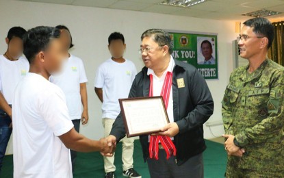 <p><strong>PROMISED LAND FOR EX-REBELS.</strong> Four former rebels receive their Certificates of Land Ownership Award (CLOA) in simple rites in Isabela province on Friday (Sept. 21, 2018), three days after President Rodrigo Duterte promised them help. The former rebels will also undergo a series of training to equip them with skills on new agricultural practices, give them livelihood, and prepare them for a normal life with their families. <em>(5ID Photo)</em></p>