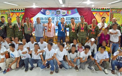 <p><strong>REBEL RETURNEES.</strong> Former members of the New People's Army, who decided to return to mainstream society, flash the peace sign as they were formally welcomed by Task Force Balik Loob during the E-CLIP turnover ceremony held at the Capitol Building in Nabunturan town, Compostela Valley on Thursday (Sept. 27, 2018). The 64 returnees were given livelihood aid and cash for the firearms they surrendered. <em>(Photo courtesy of the DND Public Affairs Service)</em></p>