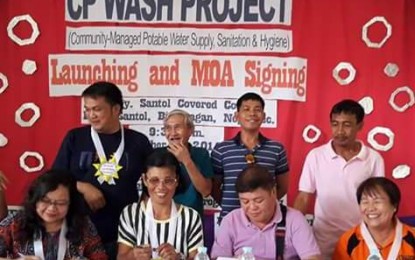 <p><strong>WATER PROJECT.</strong> Provincial Agrarian Reform Program Officer II Lucrecia Taberna (seated, left) and Mayor Emmanuel Aranda (2<sup>nd</sup> from right) with Santol Agrarian Reform Beneficiaries Association chairperson Maria Esong (2<sup>nd</sup> from left) sign the agreement for the Community-Managed Potable Water Supply and Hygiene project at Barangay Santol gymnasium on Tuesday (October 2, 2018).  <em>(Photo courtesy of  DAR-Negros Occidental II)</em></p>