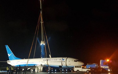 <p><strong>STUCK.</strong> File photo of the Xiamen aircraft stuck at Runway 06/24 of the Ninoy Aquino International Airport from near midnight of Aug. 16 to morning of Aug. 18, 2018. The  Civil Aviation Authority of the Philippines is expecting the final result of the probe on the incident to be out in November. <em>(File photo courtesy of Raoul C. Esperas</em>)</p>