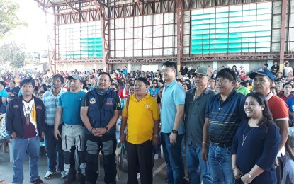 <p><strong>AID FOR LANDSLIDE VICTIMS.</strong> The National Housing Authority represented by General Manager Marcelino Escalada Jr. and the cities of San Juan and Valenzuela represented by Senators Joseph Victor "JV" Ejercito and Sherwin Gatchalian together with other officials turns over a total of PHP14 million worth of cash aid to Itogon mayor Victorio Palangdan in a ceremony in Barangay Ucab on Saturday (Oct. 13, 2018). <em>(PNA photo by Pamela Mariz Geminiano)</em></p>
<p><em> </em></p>