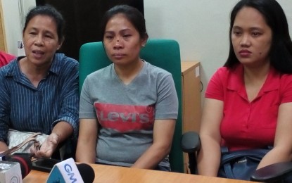 <p>BACK HOME. Bacolod City resident Corazon Abiasada (center), who was rescued from her abusive couple-employers in Kuwait, with Office of the Sectoral Concerns women sector coordinator Francisca Depamaylo (left) and OFW coordinator Debourah Ponte in a press conference at the City Mayor’s Office on Monday (October 15, 2018). <em>(Photo by Nanette L. Guadalquiver)</em></p>