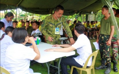 <p><strong>MEDICAL MISSION.</strong> A military doctor checks on a villager’s blood pressure during the Oct. 19-20, 2018 medical-dental mission conducted by the Army’s 6th Infantry Division inside Camp Siongco, the 6th ID’s headquarters, situated in barangay Awang, Datu Odin Sinsuat, Maguindanao. The activity benefitted a total of 427 patients. <em><strong>(Photo courtesy of 6ID)</strong></em></p>