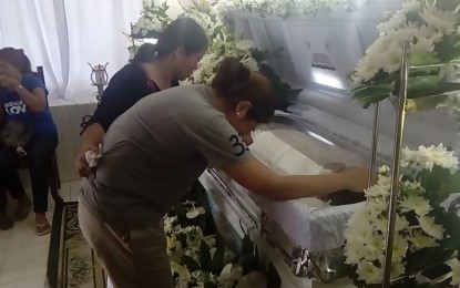 <p><strong>GRIEF.</strong> Catherine, wife of Allan Joson, a former town councilor of San Antonio, Nueva Ecija, mourns the loss of her husband, who was gunned down last Oct. 19, 2018. Joson filed his certificate of candidacy for the same post recently. <em>(Photo by Marilyn Galang)</em></p>