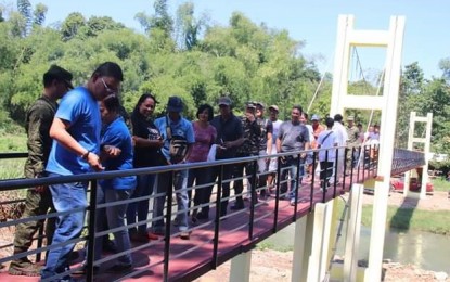 <p><strong>STEEL HANGING BRIDGE.</strong> Himamaylan City Mayor Agustin Ernesto Bascon (left) checks out the newly-constructed steel hanging bridge at Sitio Cabagal, Barangay Buenavista after the inauguration and blessing on Wednesday (October 24, 2018). (<em>Photo courtesy of 3rd Civil Military Operations Battalion)</em></p>
<p> </p>