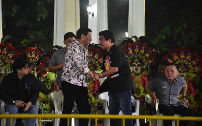 <p><strong>BEST GUEST.</strong> President Rodrigo Duterte (standing, left) is welcomed by Bacolod City Mayor Evelio Leonardia during the 39<sup>th</sup> MassKara Festival highlights at the Bacolod Public Plaza on Saturday night (October 28, 2018). Also in photo are Presidential Adviser for the Visayas Michael Lloyd Dino (seated left) and former Special Assistant to the President Christopher Lawrence 'Bong' Go. <em>(Photo courtesy of Bacolod City PIO) </em></p>