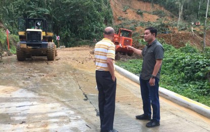 <p><strong>ERODED.</strong> Department of Public Works and Highways (DPWH) Secretary Mark Villar (right) is in Natonin town in Mountain Province on Wednesday (Oct. 31, 2018) to monitor the road clearing operation on the roads leading to the town, where a still being constructed multi-story DPWH building crumbled minutes after being engulfed in mud and rainwater from a mountain that eroded at the height of Typhoon Rosita on Tuesday afternoon. <em>(Photo from Mark Villar's Facebook Page)</em></p>