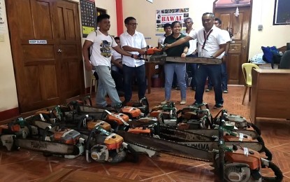 <p>Voltaire delos Angeles (first from right), Community Environment and Natural Resources Office-Quick Response Team (CENRO-QRT) forest technician 1 and team leader in Taytay, northern Palawan, is turning over the chainsaws to the Palawan Council for Sustainable Development on October 29. <em>(Photo courtesy of CENRO-QRT)</em></p>