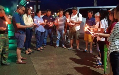 <p><em><strong>REMEMBERED.</strong></em> Journalists in the Davao Region gather in candle lighting event at the site where publisher Dennis Denora was shot dead in Panabo City. Media workers in Mindanao on Friday marked International Day to end impunity for Crimes against Journalists. <em><strong>(Photo courtesy of MIPC)</strong></em></p>