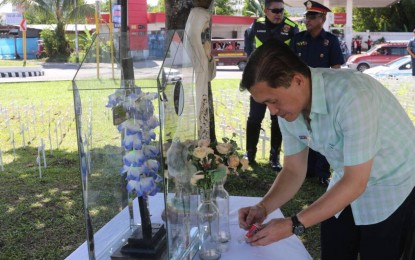 <p><strong>CANDLE FOR THE MISSING 'YOLANDA' VICTIMS.</strong> Former Special Assistant to the President Christopher Lawrence 'Bong' Go lights a candle at a mini memorial in this city set up to remember the missing victims of super typhoon Yolanda in 2013. <em>(Photo from Facebook page of Bong Go)</em></p>