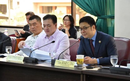 <p>The House committee on banks and financial intermediaries, chaired by Leyte Rep. Henry Ong (right), approves House Bill 8301, which seeks to provide protection of financial consumers. (<em>Photo courtesy of Rep. Ong's office) </em></p>