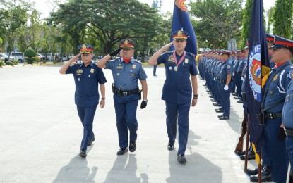 <p><strong>RESHUFFLE. </strong>Chief Supt. Joel Coronel (right) walks through police officers lined up at the turn-over ceremony of the Police Regional Office 3 (PRO-3) in Camp Olivas, San Fernando, Pampanga on Tuesday (Nov. 20, 2018). Coronel replaces Chief Supt. Amador Corpus (left), who was designated as the new head of the Criminal Investigation and Detection Group (CIDG). <em>(Photo courtesy: PRO-3)</em></p>