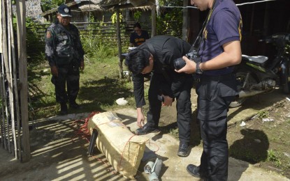 <p>Policemen check a detonating cord recovered from a house in Laoang, Northern Samar where a bomb exploded, killing 2 people and wounding 2 others on Thursday (November 22, 2018). <em>(Photo courtesy of Laoang local government) </em></p>