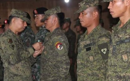 <p>Colonel Benedict Arevalo (left), commander of the Army’s 303<sup>rd</sup> Infantry Brigade, pins a commendation medal on one of the troops of the 79<sup>th</sup> Battalion who engaged the communist rebels in Barangay Washington, Escalante City last November 16. The awarding was held on Monday (November 26, 2018)  <em>(Photo courtesy of 303<sup>rd</sup> Infantry Brigade, Philippine Army ) </em></p>