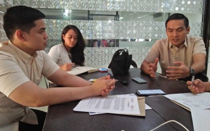 <p>PBED partnership manager Pierre Pecson (L) and policy and advocacy manager Hannibal Camua  discuss the YouthWorks PH project that seeks to help some 41,000 out-of-school youths in the country. <em>(Photo by Perla Lena) </em></p>