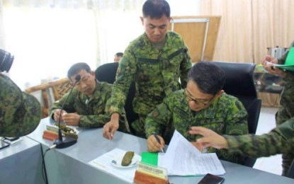 <p>Brig. Gen. Diosdado Carreon, commander of the 601st Infantry “Unifier” Brigade based in Shariff Aguak, Maguindanao, signs the Memorandum of Understanding creating Inter-Agency Task Force Magiting Monday. (<em><strong>Photo by 601st Brigade)</strong></em></p>