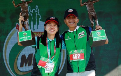 <p><strong>MARATHON CHAMPIONS.</strong> Mary Joy Tabal of Cebu and Rafael Poliquit of Davao del Norte topped their respective divisions in the 42nd MILO Marathon National Finals held in Laoag City, Ilocos Norte last Sunday. <em>(Contributed photo)</em></p>