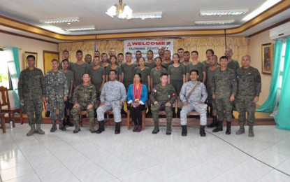 <p><strong>NEW CAFGU MEMBERS.</strong> Navy and Army officials join the new members of the Civilian Armed Forces Geographical Unit in a group photo after their military training graduation rites in Basco, Batanes, on Sunday, Dec. 9, 2018. <em>(Photo by Villamor Visaya Jr.)</em></p>