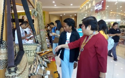 <p><strong>LOCAL PRODUCTS FOR SALE. </strong> Department of Tourism Western Visayas Regional Director Helen Catalbas admires the Ati native products during the opening of The Antique Harvest Fair at Robinson’s Mall in San Jose de Buenavista, Antique on Friday (December 14, 2018).  <em>(Photo by Annabel Petinglay)</em></p>