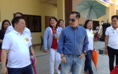 <p>Dagupan City National High School (DCNHS) Principal Medarlo de Leon (left) tours Department of Education Region 1 Director Malcolm Garma inside the DCNHS campus where the latter checked on the competitions relative to the Regional Festival of Talents. Assisted by Dagupan City Schools Division Superintendent Lorna Bugayong, De Leon also showed to Garma the newly constructed multi-storey special program in the Arts building which will be turned-over to the school soon by the city government. <em>(Photo by Liwayway Yparraguirre)</em></p>