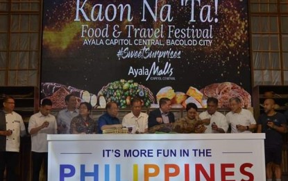 <p><strong>'KAON NA 'TA'.</strong> Negros Occidental Alfredo Marañon Jr. and Tourism Undersecretary Arturo Boncato Jr. lead the ceremonial lamb slicing and wine toasting during the opening of the three-day 'Kaon Na ‘Ta'  Food and Travel Festival at Ayala Capitol Central in Bacolod City on Wednesday afternoon (December 19,2018).  <em>(Photo by Richard Malihan/Negros Occidental Capitol PIO</em></p>