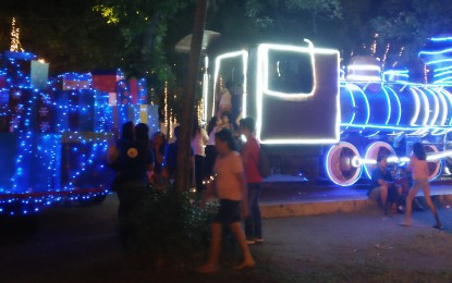 <p>The remaining parts of the Steam Locomotive 888 adorned with colorful lights amaze chilren who visit Plaza Libertad  during night time. The plaza's Christmas design will be in place until the celebration of the 'Dinagyang Festival' highlights on January 25 to 27 next year. <em>(Photo by Perla Lena) </em></p>