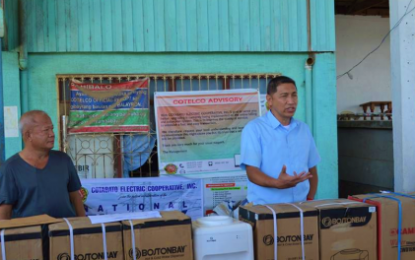 <p><strong>WATER DISPENSERS.</strong> Cotabato Electric Cooperative general manager, Godofredo Homez (right), explains the cooperative’s corporate social responsibility and why they chose to give water dispensers to education officials in Arakan, North Cotabato on Friday (Dec. 21, 2018).  The distribution of the water dispensers would bring potable drinking water to some 22,000 students in 22 public schools in Arakan. <em>(Photo courtesy of Cotelco)</em></p>