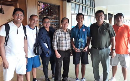 <p>CHAMPION. Boys' 14-under winner Rupert Ohrelle Tortal of Surigao City (third from right) holds his trophy during the awarding ceremony of the PSC-PHILTA Age Group Championships at the Philippine Columbian Association (PCA) in Paco, Manila. From left are Davao City coach Rollyto Litang, Ruperto Tortal, national coach Czarina Arevalo, PHILTA president  Atty. Antonio Cablitas, who also serves as presidential adviser on investments, Rupert Orhelle, PHILTA vice president Martin Misa and national coach Cris Cuarto.<em> (Contributed photo)</em>  </p>