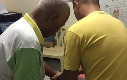 <p>Cristobal Dimpo Jikiri alias Ustadz Gulam Jikiri (left), a member of the Bangsamoro Islamic Freedom Fighter (BIFF) and the thrid most wanted person in Davao Region, is being fingerprinted by a police officer following his arrest on Friday in Pantukan, Compostela Valley province. <em><strong>Photo courtesy of PRO-11</strong></em></p>