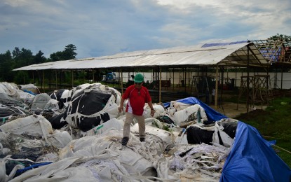 <p><strong>WASTE FROM SOUTH KOREA.</strong> An engineer checks the pile of plastic waste stored at the facility of Verde Soko Philippines Industrial Corp. inside the Phividec Industrial Estate in Barangay Santa Cruz, Tagoloan, Misamis Oriental. The 6,500 tons of trash will be shipped back to South Korea on January 9. <em>(File photo by Jigger J. Jerusalem)</em></p>