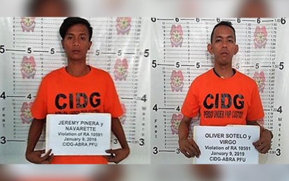 <p><strong>GUNS-FOR-HIRE NABBED.</strong> Jeremy Navarette Pinera and Oliver Virgo, suspected members of a gun-for-hire group, have been arrested during a raid at house in Abra Wednesday morning by police.<em> (PNA photo courtesy of Liza Agoot).</em></p>