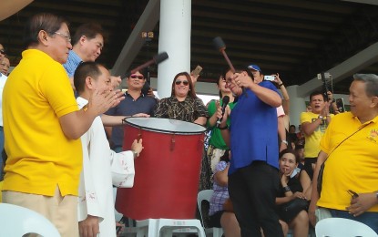 <p><strong>DINAGYANG STARTS.</strong> Mayor Jose Espinosa III (in blue polo) bangs the drum following his official declaration of the 2019 Dinagyang opening salvo. The first performance area of the opening salvo was held at the newly completed grandstand facing the Iloilo River on Friday (January 11, 2019). <em>(Photo by Perla Lena) </em></p>
