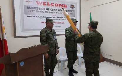 <p><strong>ASSUMPTION OF COMMAND.</strong> Army Reservist Brigadier General Erik Miguel Espina (center) passes the unit flag to Reservist Lieutenant Colonel Antonio Esmero, a university professor, who is installed by the Army Reserve Command (ARESCOM) as the new battalion commander of the 701st Ready Reserve Battalion during the assumption of command ceremony held at the 7th Regional Community Defense Group (7RCDG) conference hall on Jan. 13, 2019. Colonel Jerry Borja (left), 7RCDG chief, looks on. (<em>Photo by John Rey Saavedra)</em></p>
