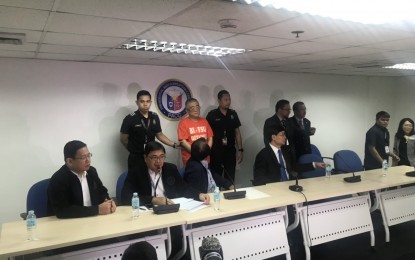 <p><strong>CHINESE FUGITIVE NABBED. </strong>Officials from the Bureau of Immigration and the Presidential Anti-Corruption Commission present to the media Xie Haojie, a former government official in China who is wanted for corruption and economic crimes, in a press conference on Wednesday (Jan. 16, 2019). <em>(PNA photo by Ferdinand Patinio)</em></p>