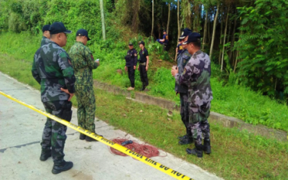 <p>Police, soldiers inspect the electrical wire used by communist rebels in setting off anti-personnel mines in Magpet, North Cotabato, which left one cop dead and 11 others hurt on Monday (Jan. 28). <em><strong>(Photo by North Cotabato PPO)</strong></em></p>