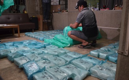 <p><strong>P1.9-B WORTH OF SHABU SEIZED.</strong> An operative of the Philippine Drug Enforcement Agency inspects the 274 kilos of shabu worth PHP1.9 billion seized from a warehouse on Antero Soriano Highway in Amaia 1, Tanza, Cavite on Sunday (Feb. 3, 2019). Two Chinese nationals were killed in the operation.<em>(PNA photo by Avito Dalan)</em></p>