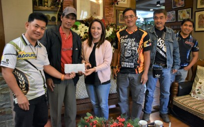 <p>PCOO Assistant Secretary Marie Rafael (3rd from left) and Metro Baguio Practical Shooting Association president Rohel Bilibli (left) turn over to Barangay Chairperson Conrado Limangan of  Balangao, Natonin town on January 19 the PHP70,000 cash aid from the 1st ASec. Marie Rafael shoot fest for a cause. Barangay Lias in Barlig town, also in Mountain Province got the same amount. Also in the photo are other officers and members of the Shilan Shooters Inc. <em>(Photo courtesy of Redjie Melvic Cawis/ PIA-CAR)</em></p>