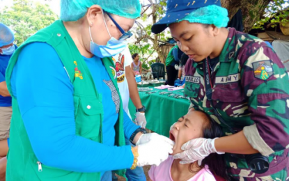 <p><strong>OUTREACH MISSION.</strong> Dentists from the Maguindanao provincial health team and Philippine Army work hand-in-hand on the dental problem of a young girl during a joint medical-dental outreach program in Ampatuan town of the province on Wednesday, Feb. 6, 2019. <em>(Photo courtesy of 6ID)</em></p>