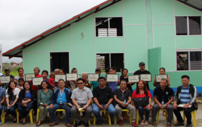 <p><strong>NEW HOUSES.</strong> TESDA-Western Visayas and Negros Occidental personnel led by Regional Director Ashary Banto with city officials of Cadiz and beneficiaries during the recent turn-over of the housing project in Barangay Daga. (<em>Photo courtesy of TESDA-Negros Occidental)</em></p>
