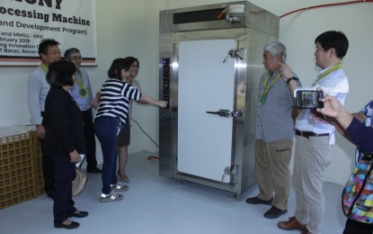 <p>MMSU officials and representatives of the Takara Inc. switch on the black garlic processing machine after a simple turnover ceremony at the MMSU S&T Park. <em>(Photo by Marco Leo A. Magno)</em></p>