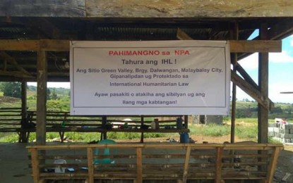 <p>A tarpaulin hangs at a shed in Sitio Green Valley, Barangay Dalwangan in Malaybalay City, Bukidnon denouncing the atrocities of the New People's Army in the area. </p>
