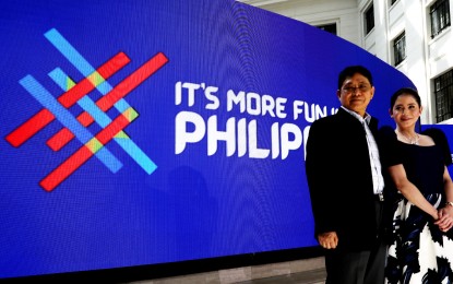 <p>Tourism Secretary Bernadette Romulo-Puyat and Interior and Local Government chief Eduardo Año unveil the refreshed logo and campaign of the country's tourism slogan "It's More Fun in the Philippines." <em>(PNA photo by Enrico Borja)</em></p>
