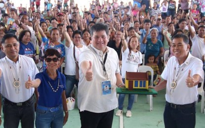 <p><strong>'YOLANDA' HOUSE.</strong> Silay City Mayor Mark Golez (center) receives a miniature replica of a “Yolanda” housing unit from National Housing Authority-Bacolod manager Alejandro Ongsuco (right) during the turnover ceremony for the first 300 of the 1,992 housing units in Barangay E. Lopez on Monday, Feb 18, 2019. <em>(Photo from Mayor Mark J. Golez's Facebook page)</em></p>