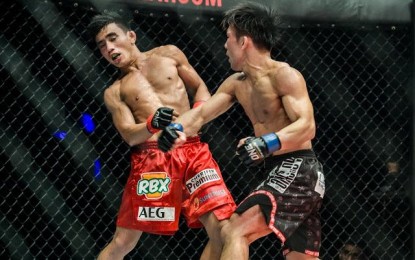 <p>Yosuke Saruta, right, connects on a right-hand strike to Joshua Pacio in their fight at ONE: Eternal Glory at the Istora Senayan in Jakarta on Jan. 19, 2019.  Saruta won over Pacio for the ONE strawweight title. <em>(Courtesy of ONE: Championship)</em></p>