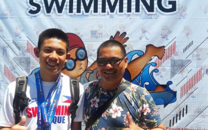 <p>Antique swimmer Gulliver Clive Clemente (left) with Binirayan Tadpoles Swimming Club head coach Jo Reuel Galindo <em>(Photo courtesy of Judith Caringal of Radyo Pilipinas2)</em></p>