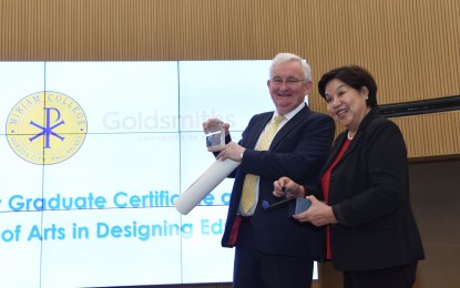 <p>Goldsmiths’ Warden Patrick Loughrey and Miriam College President Dr. Rosario O. Lapus exchange tokens during the partnership launch. <em>(Contributed photo)</em></p>